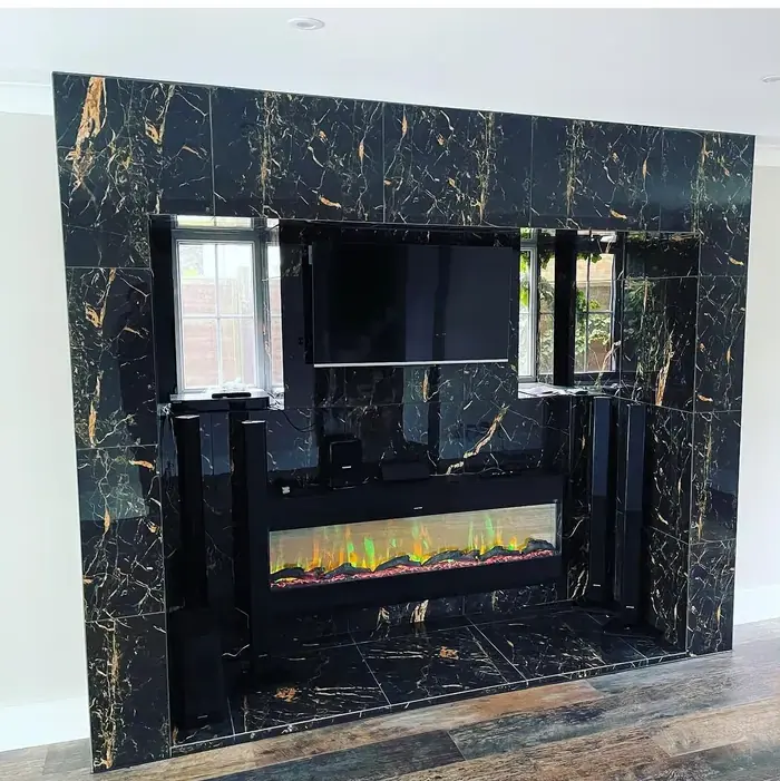 Gabriel Stano of RenovationPlanltd — book-matched marble media wall built in Harlow, Essex