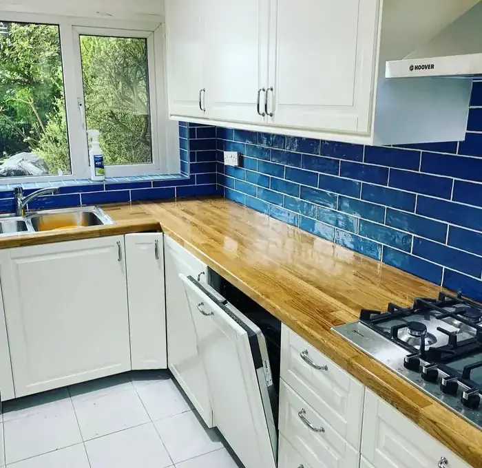 Cream shaker kitchen with metro tiling fitted by RenovationPlanltd