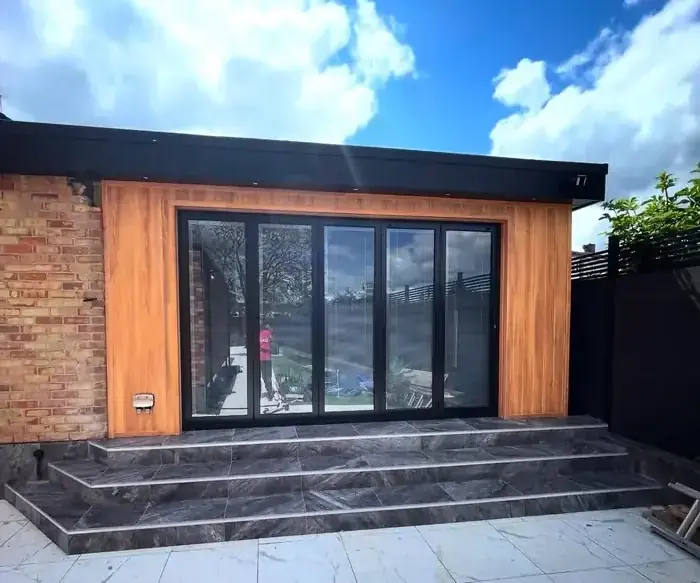 Insulated garden room with cedar cladding and sliding doors